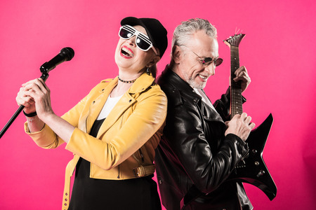 Cheerful stylish senior couple of rock and roll musicians performingの写真素材