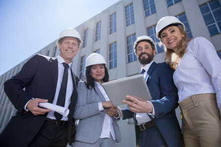 professional team of architects using digital tablet while working togetherの写真素材