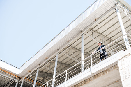 architect in suit standing and looking awayの写真素材