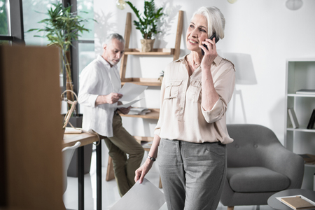 business woman talking on phone in officeの写真素材