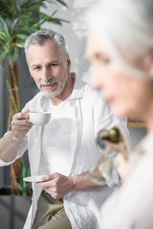 Senior businessman looking at his female colleagueの写真素材