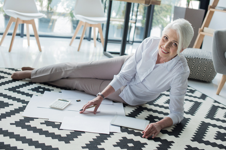 businesswoman working with documents on floorの写真素材