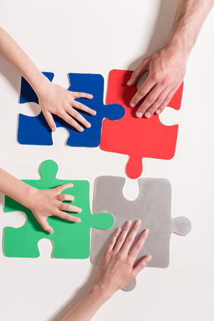 Human hands on colorful puzzle piecesの写真素材