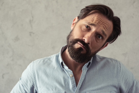 upset middle aged man looking at cameraの写真素材