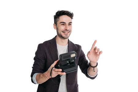 smiling man taking photo with instant vintage camera