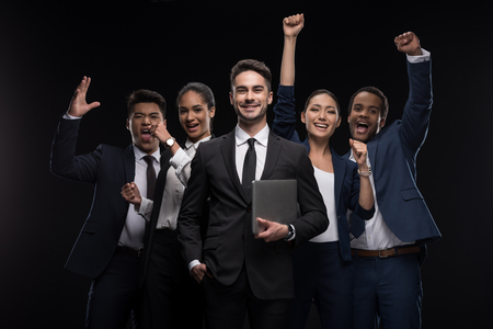 Group of excited business people standing and celebrating successの写真素材