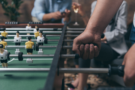 young people playing foosball indoors