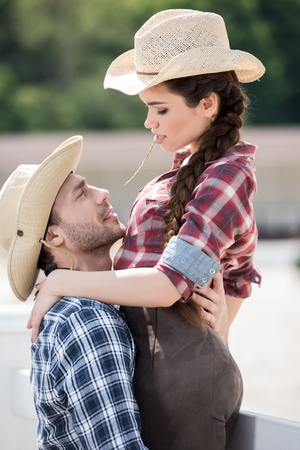 sensual cowboy style couple hugging with strawの写真素材