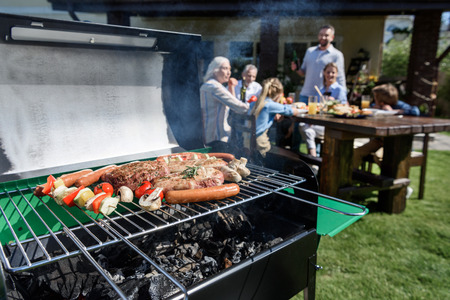 family spend time together at barbecueの写真素材