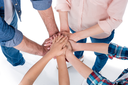 family making pile of hands isolated on white