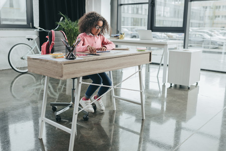 african american girl businesswoman with curly hair working in modern office