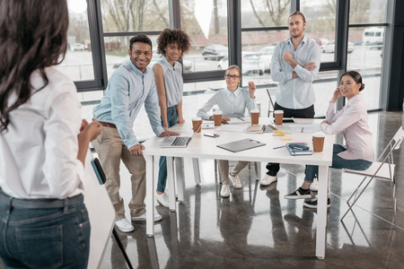 woman providing business seminar for her colleagues at office