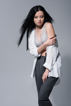 sensual young woman standing in lace bra and white shirt,の写真素材