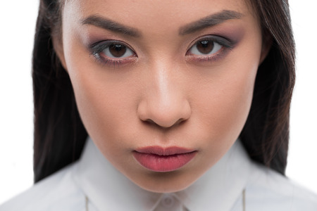 close up of beautiful serious asian girl looking at camera,の写真素材