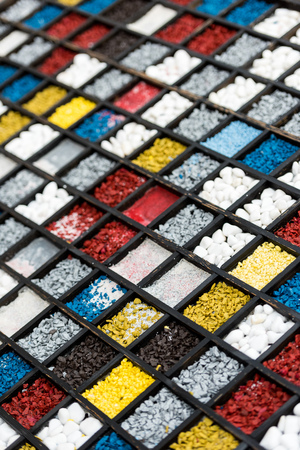 close up view of various colorful stones for decoration in wooden slots