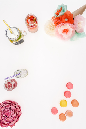 top view of refreshing lemonades, decorative flowers and macaronsの写真素材