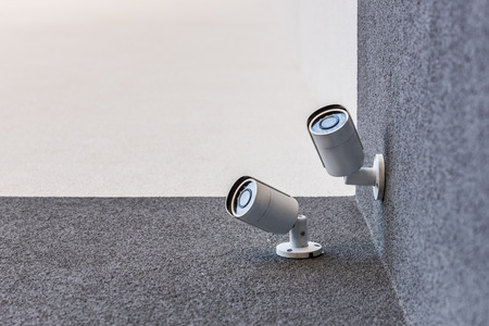 two security cameras on office building, security system concept