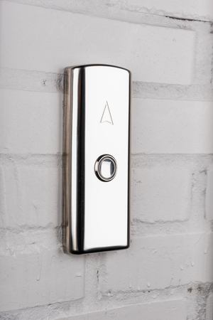 elevator button up direction on white wall