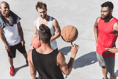 basketball team discussing strategy of game on courtの写真素材