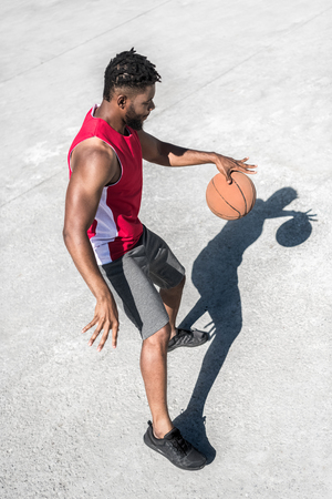 african american basketball player training on court aloneの写真素材