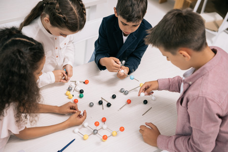 multiethnic schoolkids studying with molecular model at chemistry lessonの写真素材