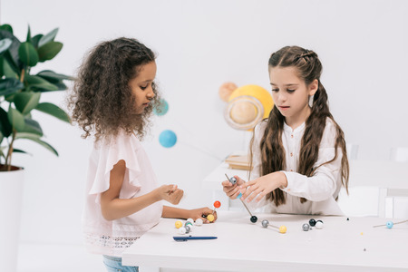 multiethnic schoolgirls working with molecular model at chemistry classの写真素材