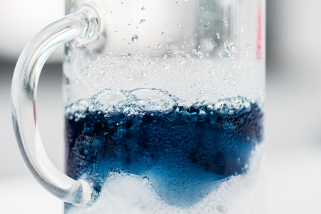 flask with blue reagent in chemical laboratoryの写真素材
