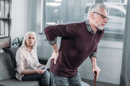 senior man suffering from strong back pain