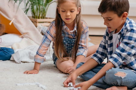 caucasian boy and girl playing domino togetherの写真素材