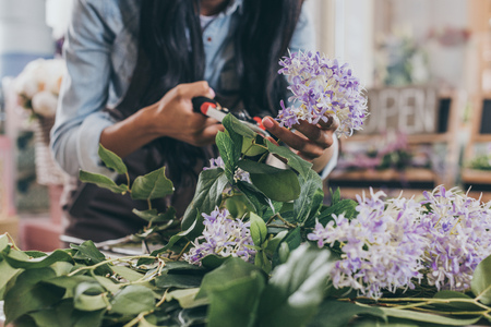 florist cutting flowers with secateursの写真素材