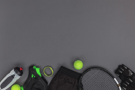 Top view of tennis equipment and sportswear, fitness tracker and sports bottleの写真素材