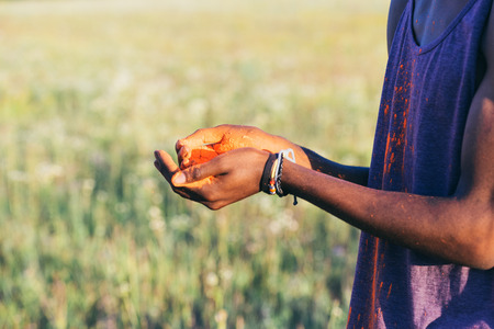 man holding colorful powder in hands during holi festivalの写真素材