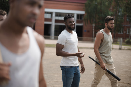 young multiethnic male baseball players on court