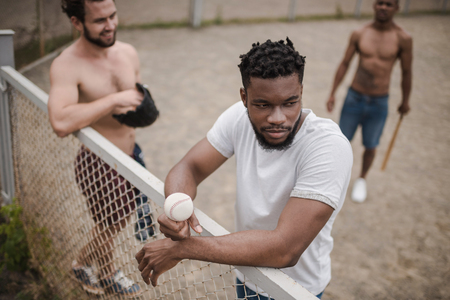 young multiethnic male baseball players on courtの写真素材