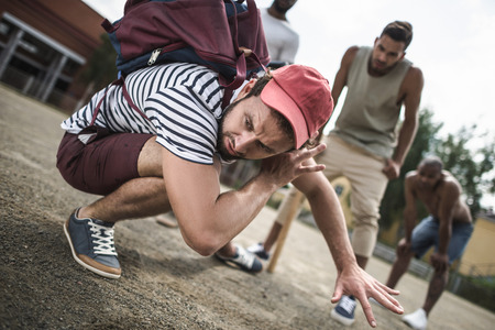 multiethnic men attacking other one with baseball bats