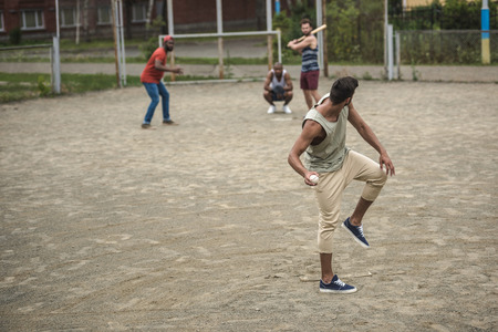 multiethnic men playing baseball on courtの写真素材