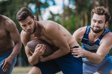 young handsome men playing football on courtの写真素材