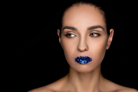 attractive fashionable woman with blue sparkles on lipsの写真素材