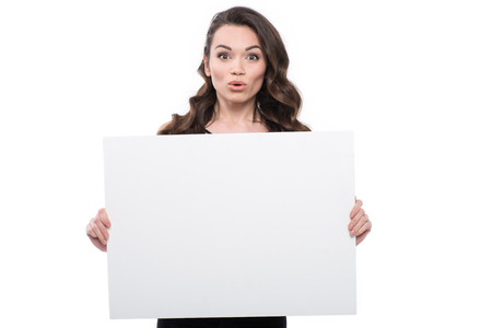 attractive surprised young woman with blank bannerの写真素材