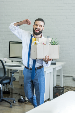 businessman with cardboard box in hand quitting jobの写真素材