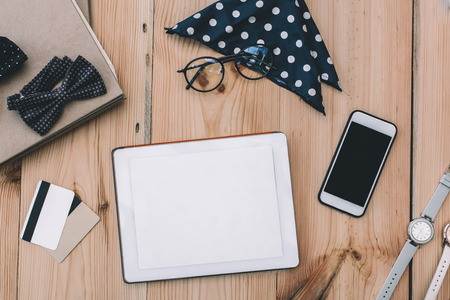 smartphone, digital tablet, credit cards and stylish accessories on wooden table topの写真素材
