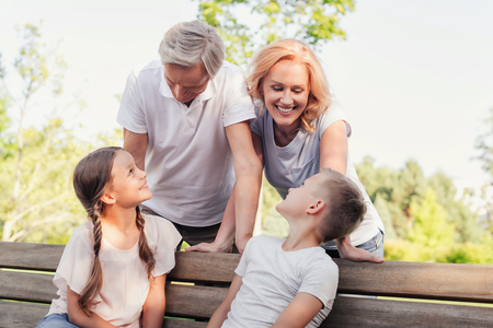 family resting together in parkの写真素材