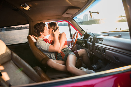 couple kissing in carの写真素材