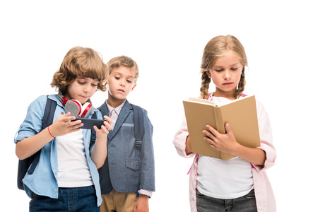 schoolboys with smartphone and schoolgirl with book