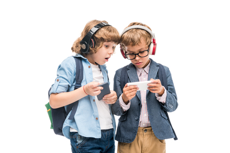 excited schoolboys using smartphonesの写真素材