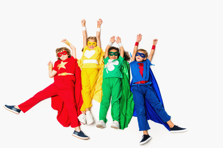 flying kids in superhero costumesの写真素材