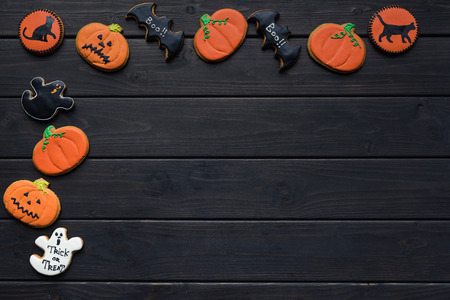 frame of homemade halloween cookies on black tableの写真素材