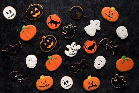 top view of composition of homemade halloween cookies on black marble tableの写真素材