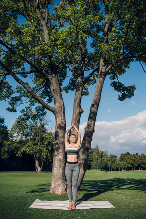 woman meditating in parkの写真素材
