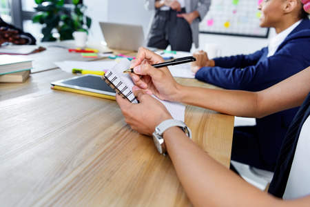 businesswoman writing in notebook